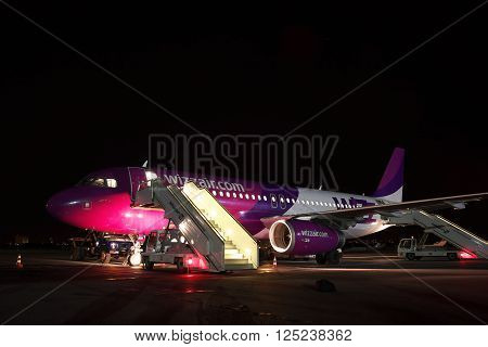 Kiev Ukraine - March 27 2011: Wizz Air Airbus A320 passenger plane parked on the apron at the airport at night