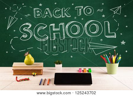 Back to school concepty with writing on blackboard and desk, apple, books, items