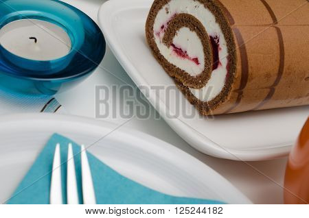 Sweet cake with blue deoration on a table