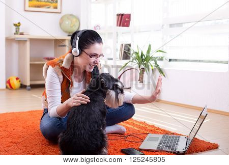 Girl With Dog Using Video Call On Laptop