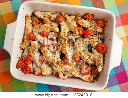 Italian chicken bake casserole with mozzarella cherry tomatoes and oregano horizontal shot