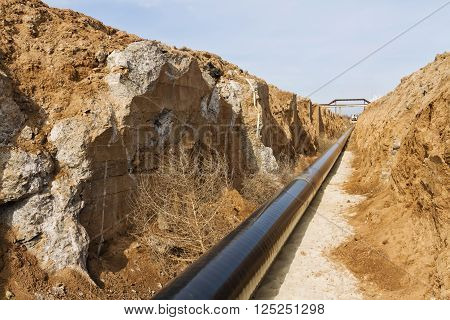pipeline is in the protective insulation laid on the bottom of the trench dug