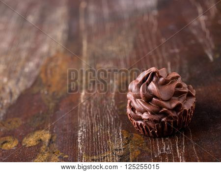 Brown chocolate candy on dark wood background