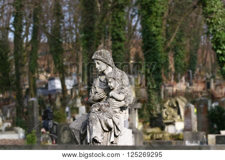 statue of a woman with a child on the grave Lychakiv memorial cemetery Lviv Ukraine