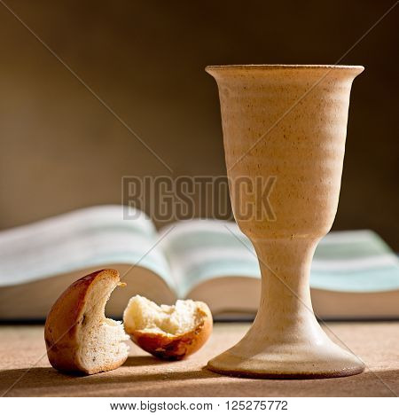 still life with chalice of wine bible and bread