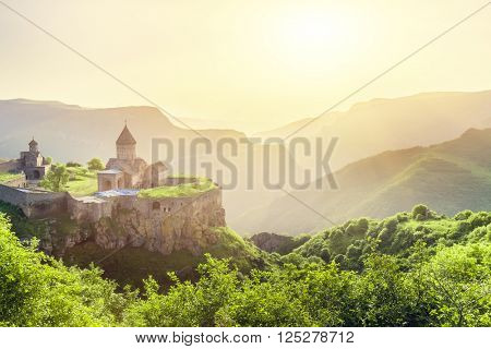 Ancient monastery in setting sun. Tatev. Armenia