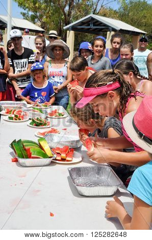 COOGEE,WA,AUSTRALIA-JANUARY 26,2016: Coogee beach festival with kids and spectators at the watermelon eating competition in Coogee, Western Australia.