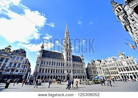 BRUSSELS BELGIUM - MARCH 16: Wide angle shot with tourists visiting the Grand Place on March 16 2016 in Brussels.