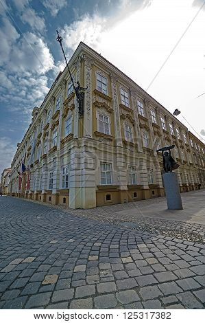 TIMISOARA ROMANIA - MARCH 20 2016: Baroque Museum and modernist statue at one intersection of streets in the historic center of Timisoara Romania. Fish-eye view.