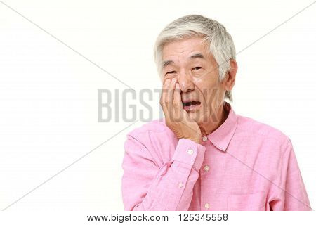 portrait of senior Japanese man suffers from toothache