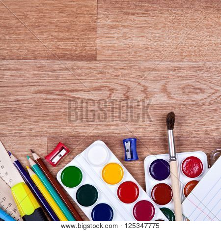 Paints, brushes, colored pencils and album - drawing tools on a desk