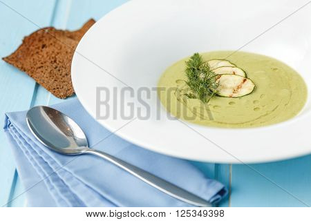 Fish cream soup on blue wood background