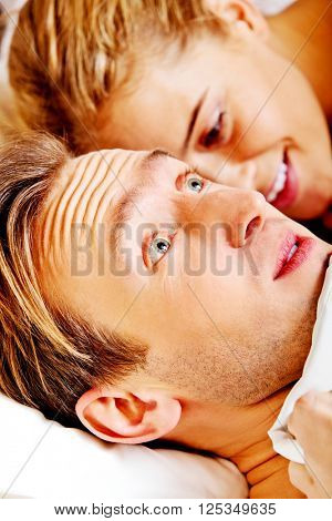 Woman whispering to her husband and he laughting