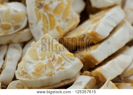 Sliced fresh raw tempeh. Close up showing texture of tempeh. Tempeh is made from soya bean and popular in some part of Asia.