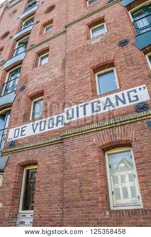 GRONINGEN, NETHERLANDS - APRIL 9, 2016: Detail of an old warehouse at a canal in Groningen, the Netherlands