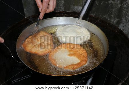 Cook Hands While Cooking The Fried Fritters Dipped In Boiling Oil