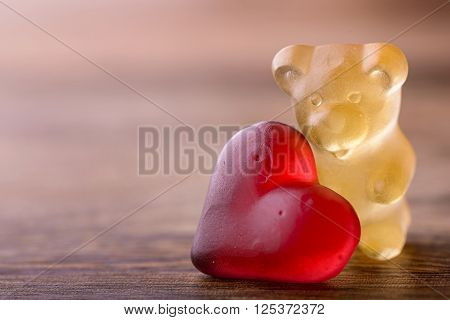 gummy bear with red heart on wood for valentines