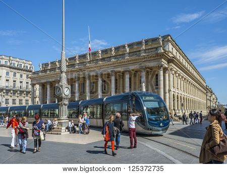 Bordeaux France - March 26 2016. Tram rolling in front of Grand Theatre de Bordeaux at sunny day. The theatre is home to the Opera National de Bordeaux and the Ballet National de Bordeaux. Bordeaux Aquitaine. France.