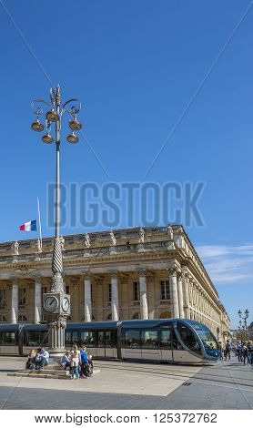 Bordeaux France - March 26 2016. Tram rolling in front of Grand Theatre de Bordeaux at sunny day. The theatre is home to the Opera National de Bordeaux and the Ballet National de Bordeaux. Bordeaux Aquitaine. France.