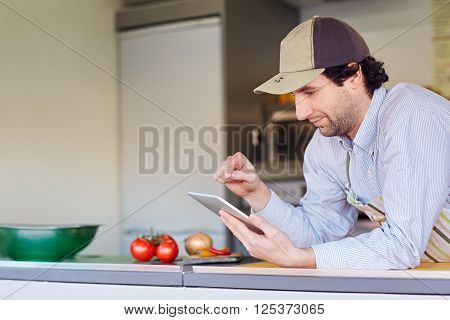 Male entrepeneur in his takeaway food kitchen using his phone