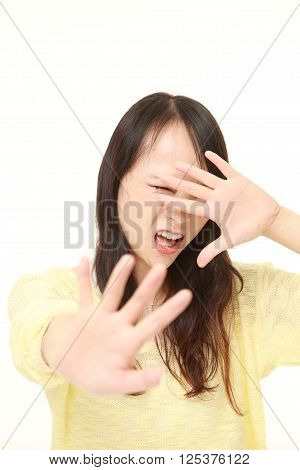 portrait of  young Japanese woman making stop gesture