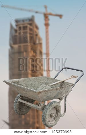 Old cart mortar, blurred background image of the building under construction.