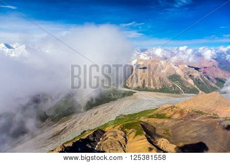 Aerial View of Asian Landscape with Desert Grassy Meadow Steppe River Stream and High Altitude Snowbound Mountains