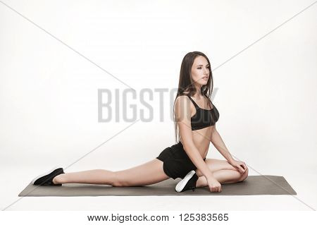 Portrait of young attractive woman doing exercises. Brunette with fit body on yoga mat. Healthy lifestyle and sports concept. Series of exercise poses.