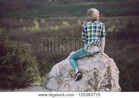 Young woman watching landscape, posing outdoor. Active lifestyle concept. 