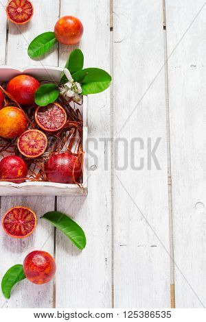 Juicy blood oranges whole and half top view space for text.