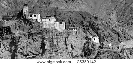 Ruins and Basgo Monastery surrounded with stones and rocks Leh Ladakh Jammu and Kashmir India black and white panoramic image