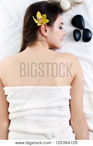 Young spa woman touching her face after beauty treatment
