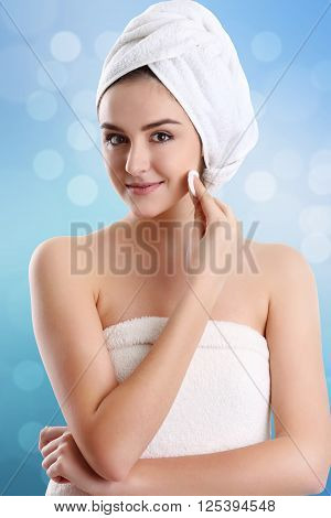 Young spa woman touching her face after beauty treatment