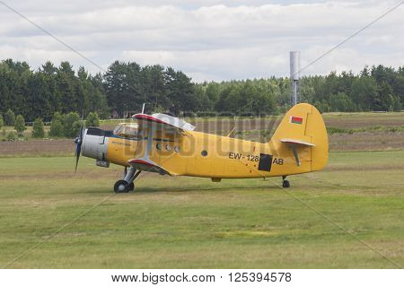 Minsk Belarus-June 21 2014: Airplane AN-2 on Takeoff and Landing Strip In Front of Spectators During Aviation Sport Event Dedicated to the 80th Anniversary of DOSAAF Foundation in Minsk on June 21 2014 Minsk Republic of Belarus