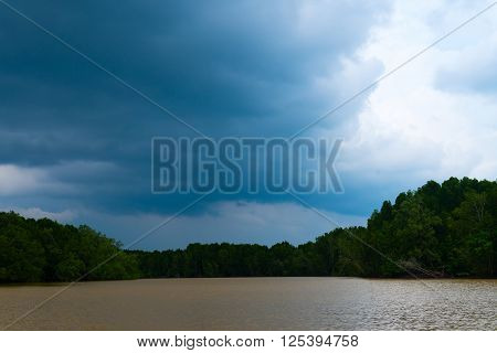 Ominous Clouds Threaten Rain Over A Tropical Estuary In Southeast Asia