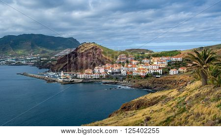 Panoramic view of Canical small town, lighthouse and yacht marina. East coast of Madeira island, Portugal.