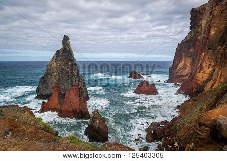 Volcanic rocks and dangerous shores of Atlantoc ocean. Madeira island rocky coast, Portugal.