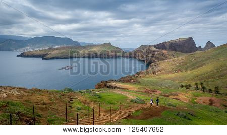Tourists couple doing their hike at the beautiful landscape od Madeira island east coast. Casa do Sardinha, Madeira, Portugal.
