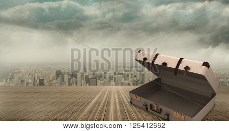 Open suitcase against cityscape on the horizon