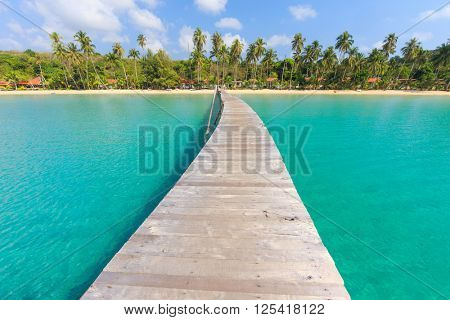 Wooden pontoon in the turquoise tropical sea of Bang Bao Bay in Ko Kood island, Thailand . 