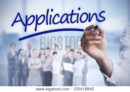 Mid section of businessman writing with marker against word applications underlined