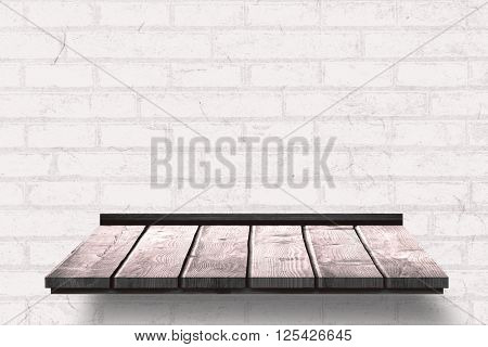 Wooden shelf against bricks wall