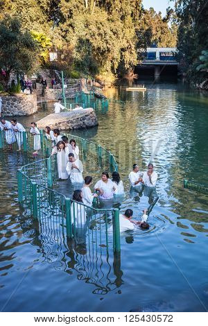 YARDENIT, ISRAEL - JANUARY 21, 2012: Christian pilgrims enter Jordan River waters. They make  baptism ceremony in honor of Jesus Christ's baptism here