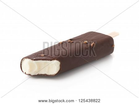 Bitten chocolate covered vanilla ice cream bar with nuts on a wooden stick, isolated over the white background