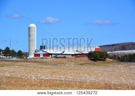 BROMONT QUEBEC CANADA APRIL 10 2016: Early spring farm in country side of Bromont it is in the Brome-Missisquoi Regional County Municipality.