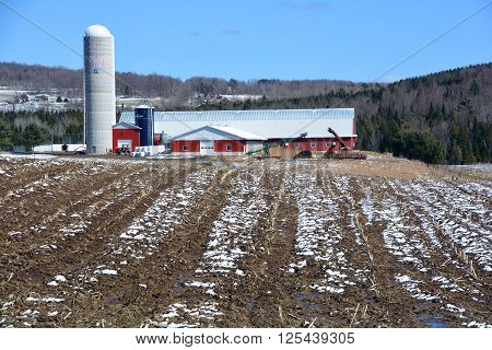 BROMONT QUEBEC CANADA APRIL 10 2016: Early spring farm in country side of Bromont it is in the Brome-Missisquoi Regional County Municipality.