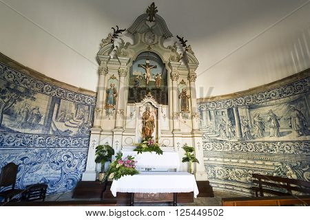 VILA DO CONDE, PORTUGAL - September 20, 2015: View of the chapel rococo style altarpiece with a statue of Our Lady holding the Child Jesus on September 20, 2015 in Vila do Conde, Portugal