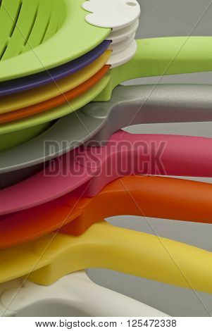 Group of colorful plastic containers in stack