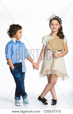 Cute boy and girl or teenagers in full length casual style blue jeans posing.