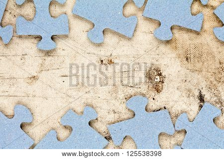 Blue puzzle frame with old canvas background for copy-space